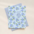 Greeting card with blue floral pattern and text on a beige background